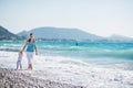 Mother walking with baby on seashore