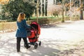 Mother walking with baby stroller