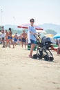 Mother walking on beach and push baby carriage Royalty Free Stock Photo