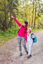 Mother walking with her child in warm sunny autumn day