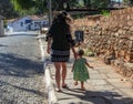 Mother walking with her daughter in the tourist town of Pirenopolis