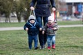 Mother walking with her two children off the leash