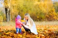 Mother walks with baby in a beautiful autumn park