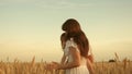 Mother walks with child in field with wheat. a woman farmer with a child in field. happy family, eco tourism. baby in Royalty Free Stock Photo