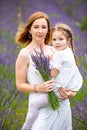 Mother walks with her little daugher holding a bouquet of lavander, Czech republic