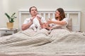 Mother wants to take baby boy from father, parents and infant child on home bed. Problems of a man and a woman with a newborn baby