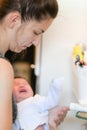 Mother washes the child. Unrecognizable mom bathes her son in the sink