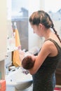 Mother washes the child. Unrecognizable mom bathes her son in the sink Royalty Free Stock Photo