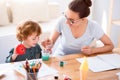 Mother washing a painting brush Royalty Free Stock Photo