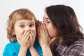 Mother whispers secret to her little son Royalty Free Stock Photo