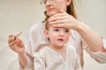 A mother woman measures the temperature of a sick toddler baby wit Royalty Free Stock Photo