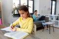 Mother working and daughter studying at home