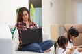 Mother working from home with kids. Quarantine and closed school during coronavirus outbreak. Children make noise and disturb Royalty Free Stock Photo