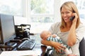 Mother working in home office with baby Royalty Free Stock Photo