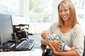 Mother working in home office with baby Royalty Free Stock Photo