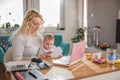 Mother working at home office with her baby Royalty Free Stock Photo