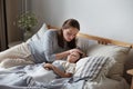 Mother worried son health check hot forehead lying on bed pillow. Preschooler feeling head pain ache Royalty Free Stock Photo