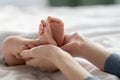 Mother's Care. Closeup Shot Of Loving Mom Holding Feet Of Newborn Baby In Hands Royalty Free Stock Photo