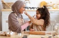 Mother's Day Concept. Little Girl Having Fun With Muslim Mom In Kitchen Royalty Free Stock Photo