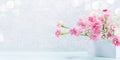 Gentle pink carnations and gypsophila flowers on white stand on light grey. Mother& x27;s day. Banner. Royalty Free Stock Photo
