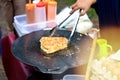 mother's hand is cooking egg martabak, traditional food from indonesia.