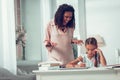 Emotional mid-adult Afro-American woman yelling at little upset unhappy daughter