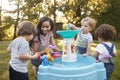 Mother And Young Children Playing With Water Table In Garden Royalty Free Stock Photo