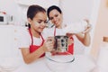 Mother and Young Daughter Percolate Flour for Cake