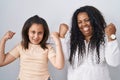 Mother and young daughter standing over white background celebrating surprised and amazed for success with arms raised and eyes Royalty Free Stock Photo