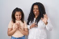 Mother and young daughter standing over white background disgusted expression, displeased and fearful doing disgust face because Royalty Free Stock Photo