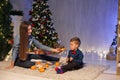 Mom and young boy open Christmas presents Christmas tree new year holiday Royalty Free Stock Photo