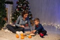 Mom and young boy open Christmas presents Christmas tree new year holiday Royalty Free Stock Photo