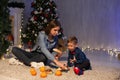 Mom and young boy open Christmas presents Christmas tree new year holiday Royalty Free Stock Photo