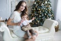 Mother and young son at home near Christmas tree Royalty Free Stock Photo