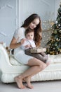 Mother and young son at home near Christmas tree Royalty Free Stock Photo