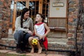 A mother and young son sitting on their porch in front of their new home. Royalty Free Stock Photo