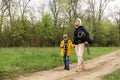 A mother and a young son walk in the park. A woman with a tourist mat and a boy walk about the road in the park, the forest Royalty Free Stock Photo