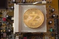 Crypto currency gold coin zcash on a motherboard