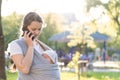 Motherhood, care, infants, summer, communication, parenting concept - Young beautiful mom with a newborn baby in a sling Royalty Free Stock Photo