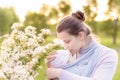 Motherhood, care, infants, summer, parenting concept - Young beautiful mom with a newborn baby in a sling walks and Royalty Free Stock Photo