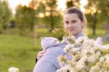 Motherhood, care, infants, summer, parenting concept - Young beautiful mom with a newborn baby in a sling walks and Royalty Free Stock Photo