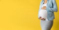 Motherhood, femininity, love, care, waiting, hot summer - bright banner Close-up unrecognizable pregnant woman in shirt Royalty Free Stock Photo