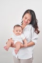 Motherhood and lifestyle concept. Smiling young mother with little baby at home Royalty Free Stock Photo