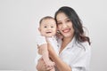 Motherhood and lifestyle concept. Smiling young mother with little baby at home Royalty Free Stock Photo