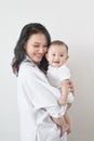 Motherhood and lifestyle concept. Smiling young mother with little baby at home Royalty Free Stock Photo