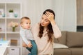 Tired mother with baby boy at home Royalty Free Stock Photo