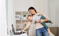 Happy mother with baby and laptop working at home Royalty Free Stock Photo