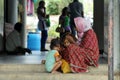 Motherhood - A poor Indian mother takes care of her children on street