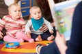 Mothers With Children At Baby Group Listening To Story Royalty Free Stock Photo