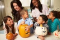 Mothers And Children Making Halloween Lanterns